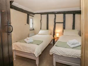 a room with two beds with towels on them at Friars Retreat in Sudbury