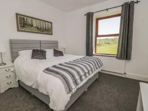 a bedroom with a large bed and a window at Carr House in Balderstone