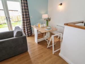 a living room with a table and a couch at The Button Box in Huddersfield