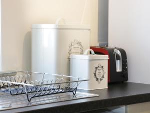 a dish drying rack next to a toaster and cups at Ramblers in Kerry