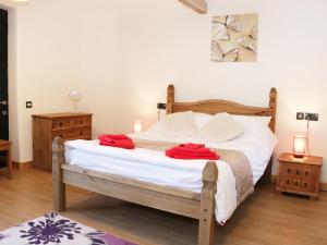 a bedroom with a bed with red towels on it at Ramblers in Kerry