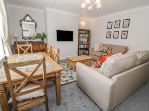 a living room with a couch and a table at Salee Cottage in Newbiggin-by-the-Sea