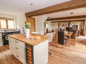 a kitchen and living room with a table and a dining room at Pentre Fawr in Llanddewi Ystradenny