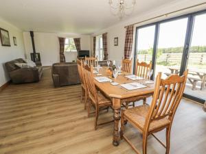 a dining room with a table and chairs at Rede River Cottage in Corsenside