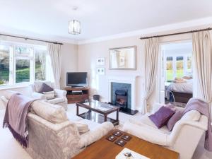 a living room with two couches and a fireplace at 2 Bittadon Cottages in Barnstaple