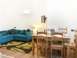 a living room with a table and a blue couch at Woodside Cottage in Kerry