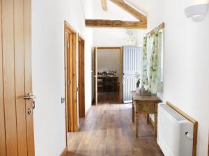 a hallway with a door and a table in a room at Woodside Cottage in Kerry