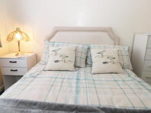 a blue and white bed with two birds on it at Seaspray in Withernsea