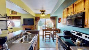 a kitchen with a sink and a dining room at Adventure Villa #3282 in Moab