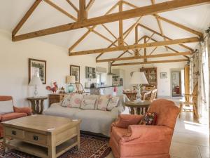 a living room with a couch and a table at Cow Byre in Great Habton