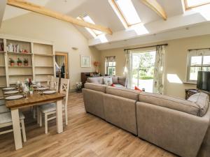 a living room with a couch and a table at Providence Cottage in Easingwold