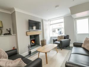 a living room with a couch and a fireplace at Ivy Bank in Windermere
