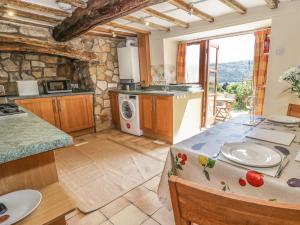 a large kitchen with a table in a room at The Cottage in Llangollen