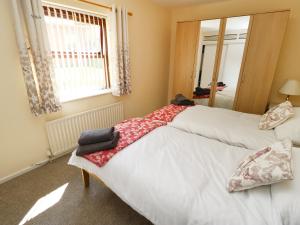 two beds in a room with a mirror at West End House in Bradford