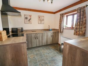 a kitchen with wooden cabinets and a sink at Shepherd's View in Meadowtown