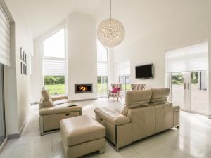 a living room with a couch and chairs and a fireplace at P'lace of Glassaugh in Banff