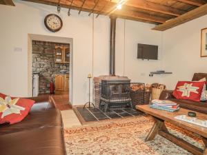 a living room with a fireplace and a couch at Milltown House in Turriff