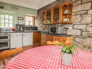 a kitchen with a table with a potted plant on it at Milltown House in Turriff