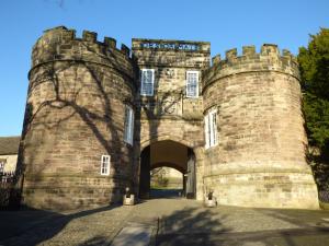 an entrance to a castle with a person standing in front at Evergreen in Ilkley