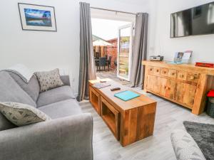 a living room with a couch and a coffee table at The Old Mill Hideaway in Ellerton