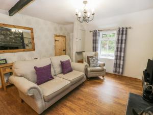a living room with a couch and a chair at Ty Coed in Llanberis