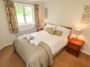 a bedroom with a bed with two white towels on it at Latterbarrow in Ambleside