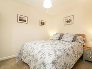 a bedroom with a bed with a white bedspread at Enginefield in Ilfracombe
