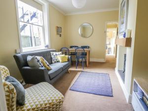 a living room with a couch and a table at The Garden Flat in Harrogate