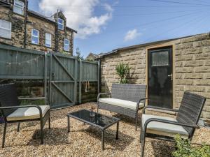 a patio with two chairs and a table at The Garden Flat in Harrogate