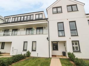a white house with black windows at Seaspell Beach House in Padstow