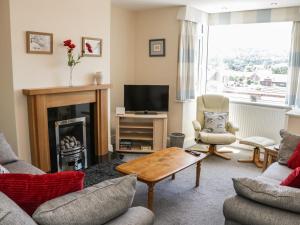 a living room with a fireplace and a tv at Belle Vue in Ludlow