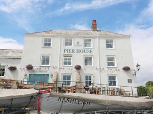 a white building with a pier house at Little Pippin in Carlyon Bay