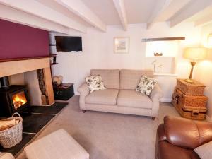 a living room with a couch and a fireplace at Pear Tree House in Whitby