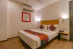 a bedroom with a large bed in a room at FabHotel Hargobind Enclave in New Delhi