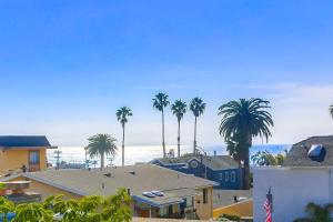 a view of a beach with palm trees and houses at Opal Oasis in San Diego