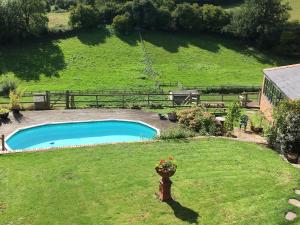 a backyard with a swimming pool in a field at The Lookout in Llangarren