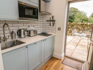 a kitchen with a sink and a counter top at The Bothy in Arncliffe