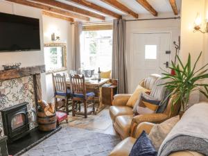 a living room with a couch and a fireplace at 31 Riverside in Bridgnorth