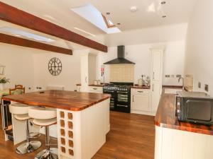 a kitchen with white cabinets and a counter top at The Cottage at Grange Farm Barns in Horncastle