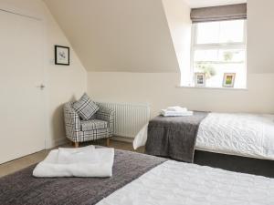 A bed or beds in a room at Bonjedward Mill Farm Cottage