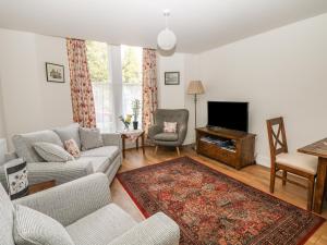 a living room with a couch and a tv at The Haven in Buxton