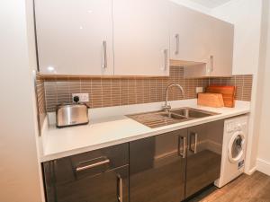 a kitchen with a sink and a dishwasher at The Haven in Buxton