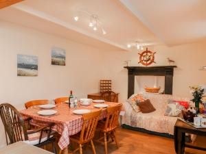 a dining room with a table and chairs and a bed at Mount Pleasant in Boscastle