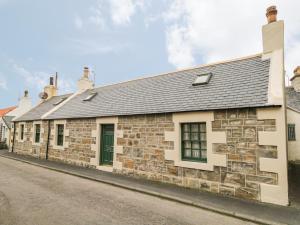an old stone building on a street at 83 Seatown in Buckie
