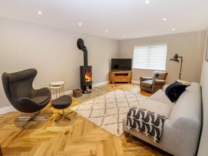 a living room with a couch and a fireplace at Farm View House in Melton Mowbray