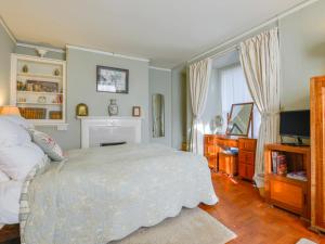 a bedroom with a bed and a television in it at Garfield House in South Brent