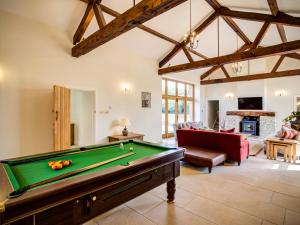a living room with a pool table in a room at Lower Farm Barn in Oxford