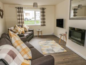 a living room with a couch and a fireplace at Ty Mon in Menai Bridge