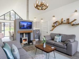 a living room with a couch and a fireplace at Restharrow Lodge in Bamburgh