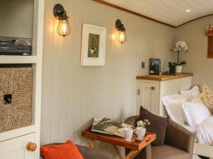 a living room with a couch and a table at Little Silver Owl in High Bickington